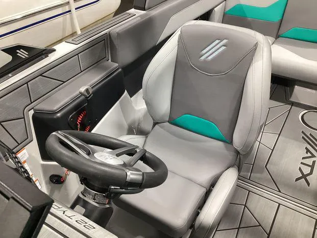 Slide: The Image of 2024 ATX Surf Boats 22ATX interior with gray and teal seating, steering wheel, and modern design. - 12