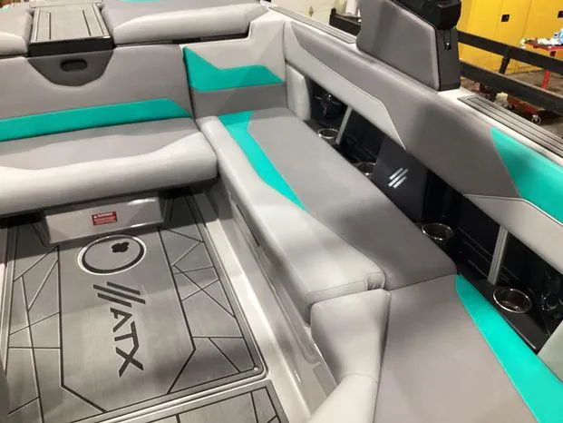 Slide: The Image of 2024 ATX Surf Boats 22ATX interior with gray and teal seating. - 13