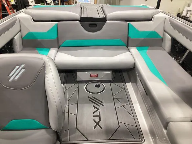 Slide: The Image of 2024 ATX Surf Boats 22ATX interior with gray and teal seating. - 14