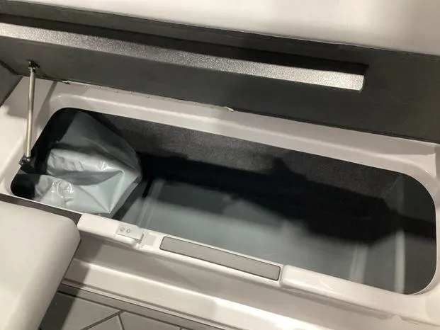 Slide: The Image of 2024 ATX Surf Boats 22ATX storage compartment, open lid, spacious interior. - 21