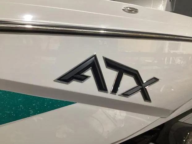 Slide: The Image of 2024 ATX Surf Boats 22ATX logo on white and teal boat exterior. - 5