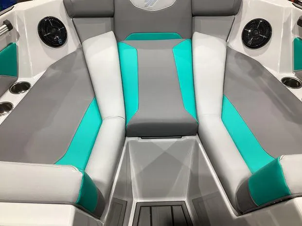 Slide: The Image of 2024 ATX Surf Boats 22ATX interior with gray and teal seating, cup holders, and speakers. - 9