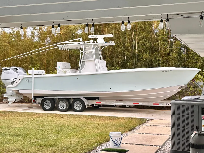 Slide: The Image of 2007 SeaVee 320B boat on trailer, parked outdoors under string lights. - 1