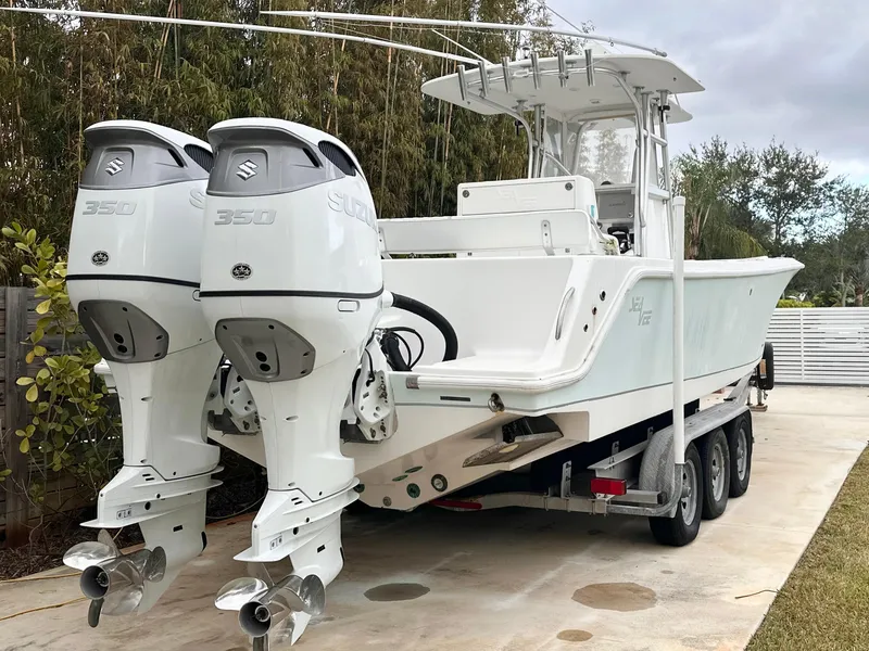 Slide: The Image of 2007 SeaVee 320B boat with dual Suzuki 350 engines on a trailer. - 2
