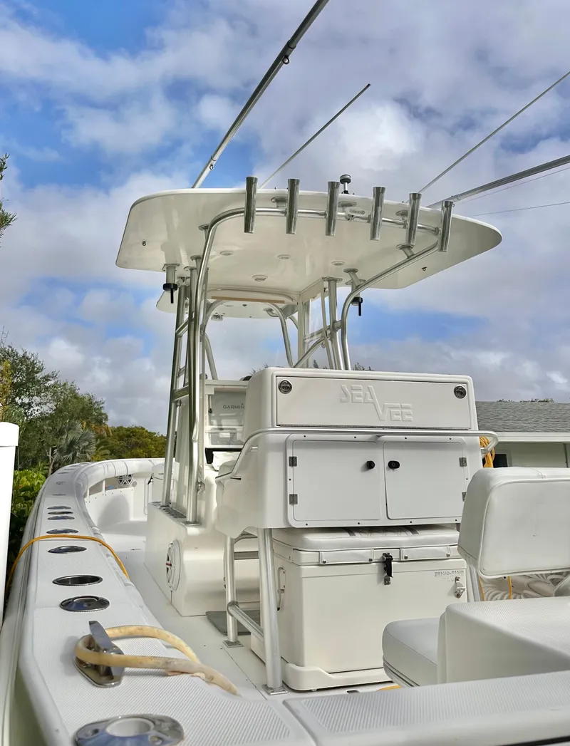 Slide: The Image of 2007 SeaVee 320B boat with T-top and rod holders under a cloudy sky. - 4
