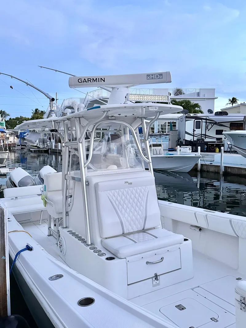 Slide: The Image of 2007 SeaVee 320B boat docked, featuring Garmin equipment and sleek white design. - 7