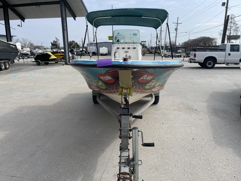 Slide: The Image of 1999 Bayliner 17cc boat with colorful graphics, parked on a trailer in a lot. - 3