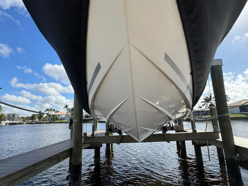 Slide: The Image of 2023 Sea Fox 268 Commander boat on lift, viewed from below, with blue sky background. - 10