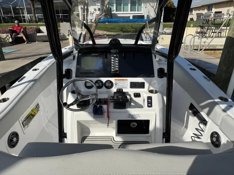 Slide: The Image of 2023 Sea Fox 268 Commander boat cockpit with steering wheel and control panel. - 11