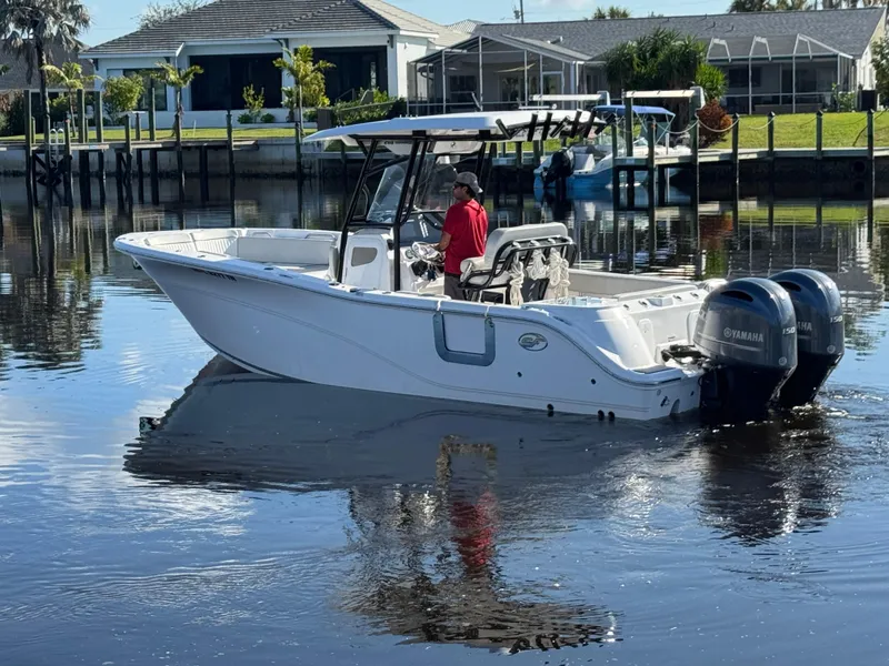 Slide: The Image of 2023 Sea Fox 268 Commander boat on calm water with dual Yamaha engines. - 2