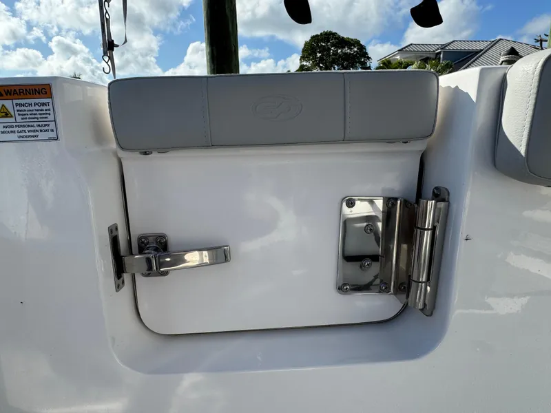 Slide: The Image of 2023 Sea Fox 268 Commander boat hatch with stainless steel hinges under a blue sky. - 24