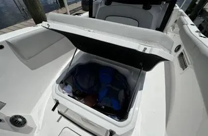 Slide: The Image of 2023 Sea Fox 268 Commander storage compartment open, showing interior space and contents. - 28