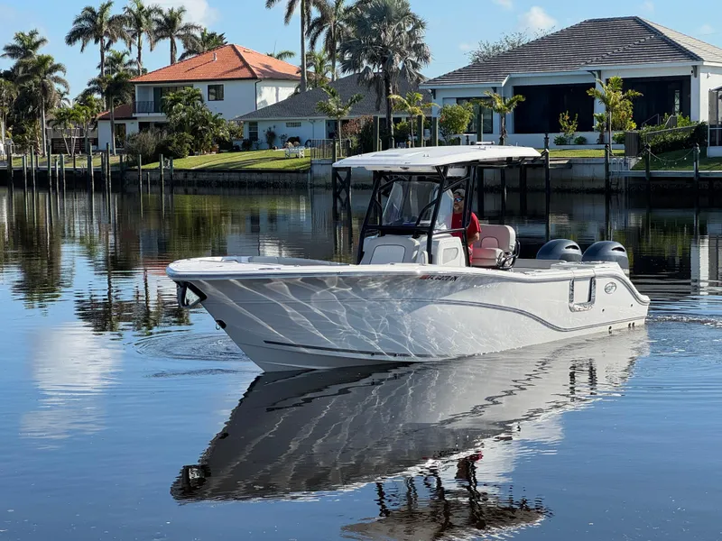 Slide: The Image of 2023 Sea Fox 268 Commander boat on calm water near waterfront homes. - 4