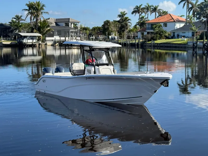 Slide: The Image of 2023 Sea Fox 268 Commander boat on a calm, scenic waterfront with palm trees. - 5