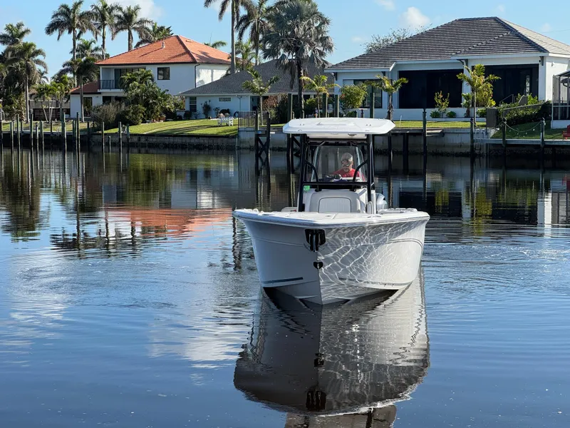 Slide: The Image of 2023 Sea Fox 268 Commander boat on calm water near waterfront homes. - 6