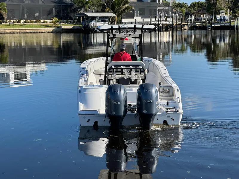 Slide: The Image of 2023 Sea Fox 268 Commander boat on calm water, rear view with dual engines. - 7