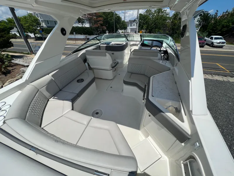 Slide: The Image of 2022 Sea Ray SLX 310 boat interior with spacious seating and modern design. - 11