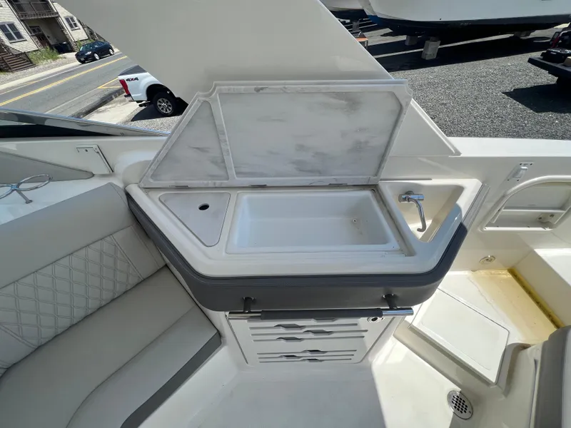 Slide: The Image of 2022 Sea Ray SLX 310 boat interior with sink and storage area. - 16