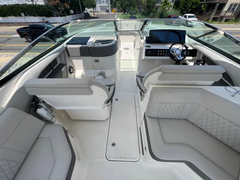 Slide: The Image of 2022 Sea Ray SLX 310 boat interior with modern seating and steering console. - 17