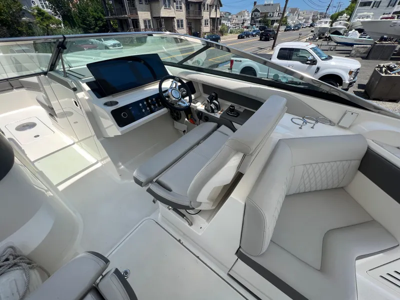 Slide: The Image of 2022 Sea Ray SLX 310 boat interior with modern dashboard and seating. - 18