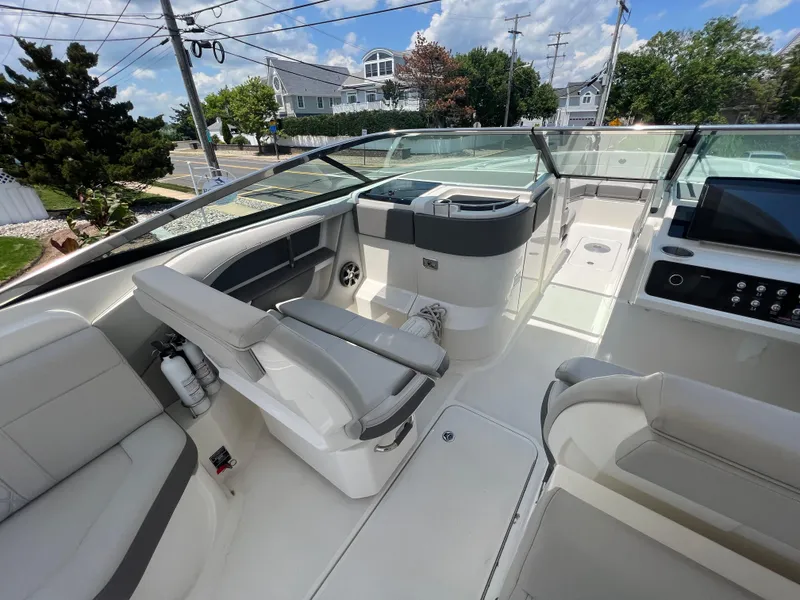 Slide: The Image of 2022 Sea Ray SLX 310 boat interior with modern seating and control panel. - 19
