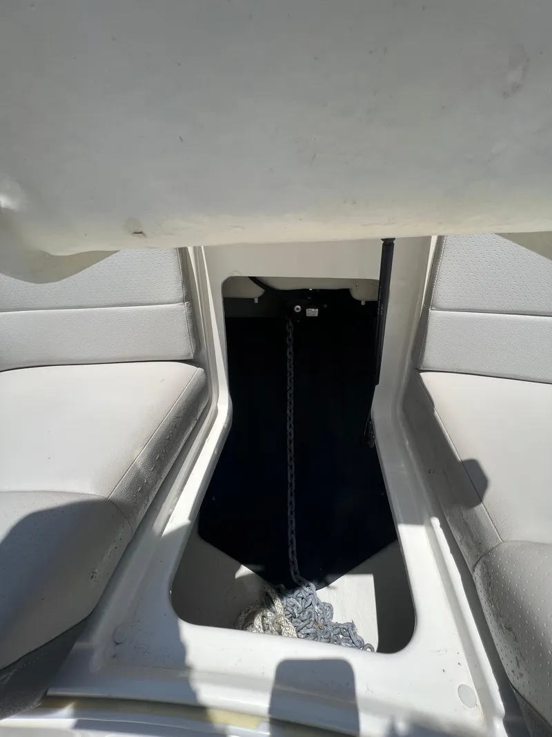 Slide: The Image of Interior view of a 2022 Sea Ray SLX 310 boat, featuring seating and storage area. - 29