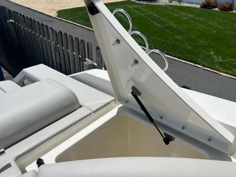Slide: The Image of Open storage compartment on 2022 Sea Ray SLX 310 boat, showcasing sleek design and functionality. - 34