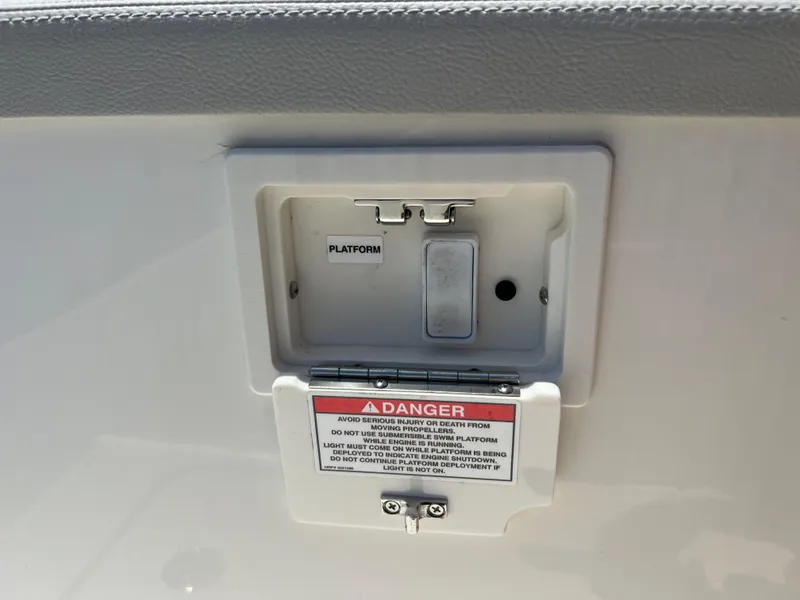 Slide: The Image of Control panel on a 2022 Sea Ray SLX 310 boat with safety warning. - 36