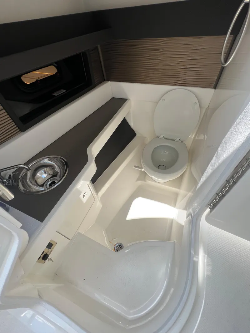 Slide: The Image of 2022 Sea Ray SLX 310 boat bathroom with sink and toilet. - 39