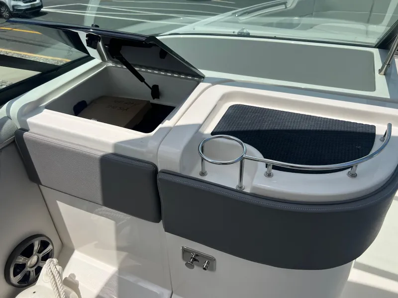 Slide: The Image of Interior of 2022 Sea Ray SLX 310 boat with storage compartment and cup holder. - 41