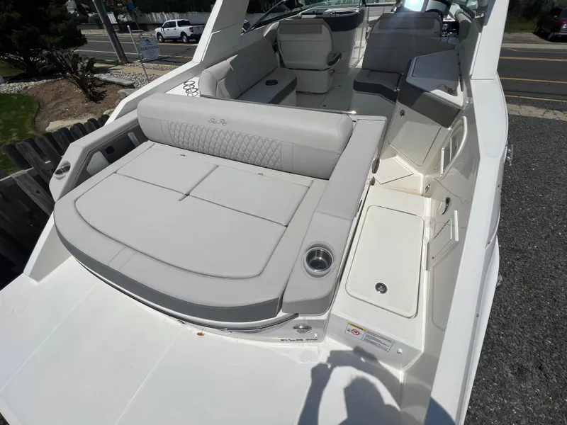 Slide: The Image of 2022 Sea Ray SLX 310 boat with spacious seating and modern design. - 8
