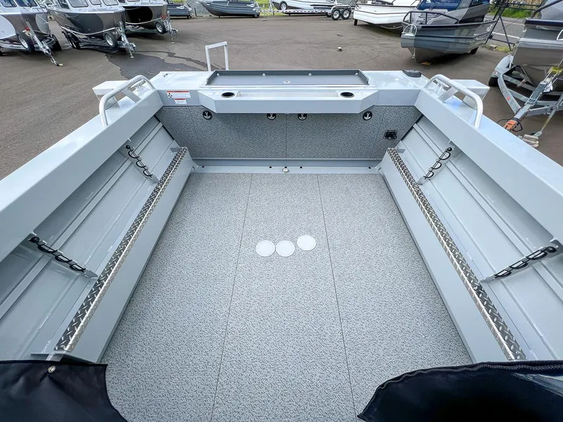 Slide: The Image of 2023 Hewescraft 200 PRO V ET boat interior, spacious deck with storage compartments. - 13