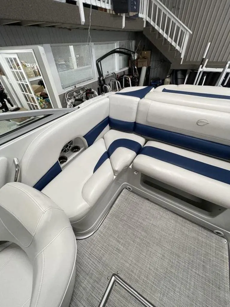 Slide: The Image of 2020 Crownline 205 SS boat interior with white and blue seating. - 17