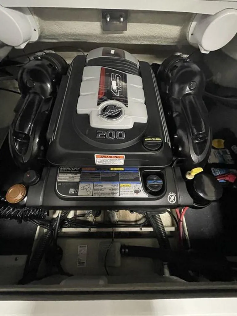 Slide: The Image of Engine compartment of a 2020 Crownline 205 SS boat, featuring a Mercury 4.5L engine. - 20