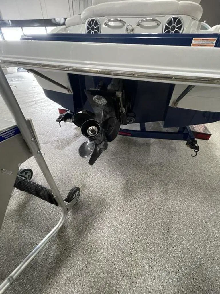 Slide: The Image of 2020 Crownline 205 SS boat stern with propeller in a showroom setting. - 21