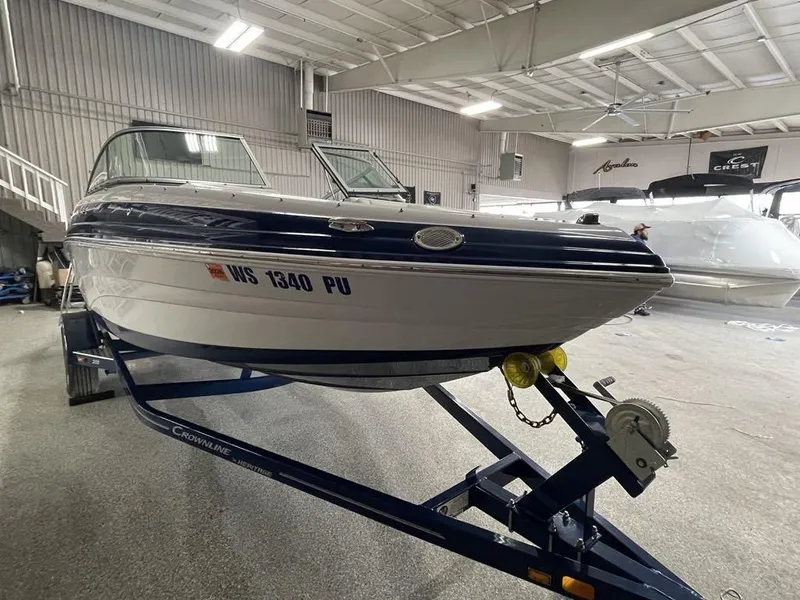 Slide: The Image of 2020 Crownline 205 SS boat on trailer in indoor showroom. - 3