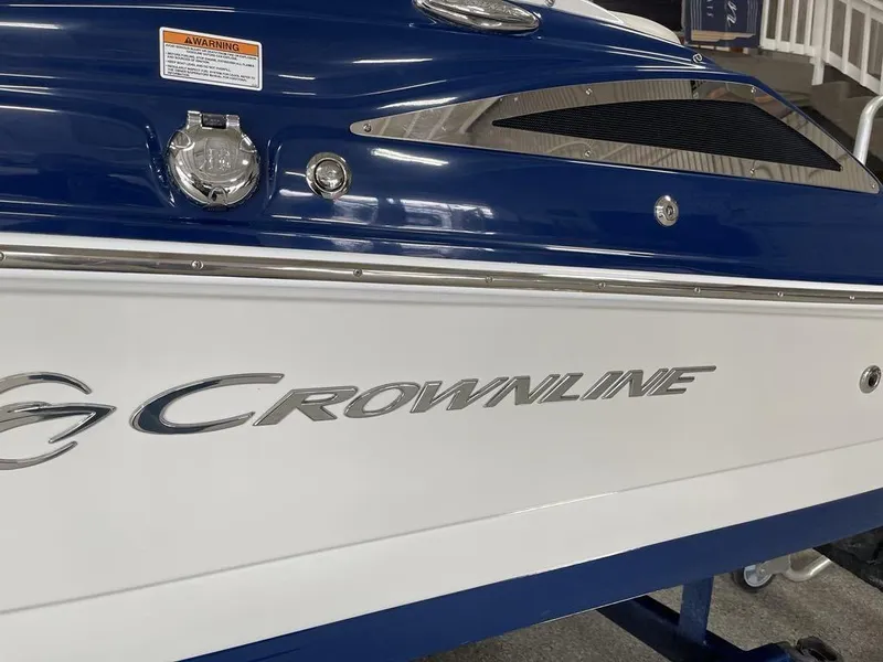 Slide: The Image of 2020 Crownline 205 SS boat, blue and white exterior, close-up view. - 5