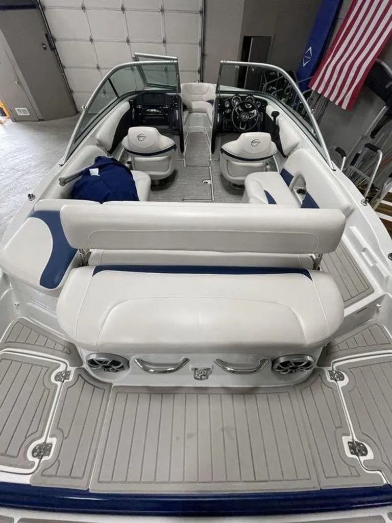Slide: The Image of 2020 Crownline 205 SS boat interior with white seating and modern dashboard. - 8