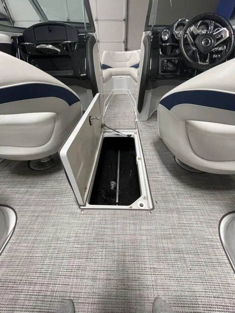 Slide: The Image of 2020 Crownline 205 SS boat interior with open floor storage compartment. - 9