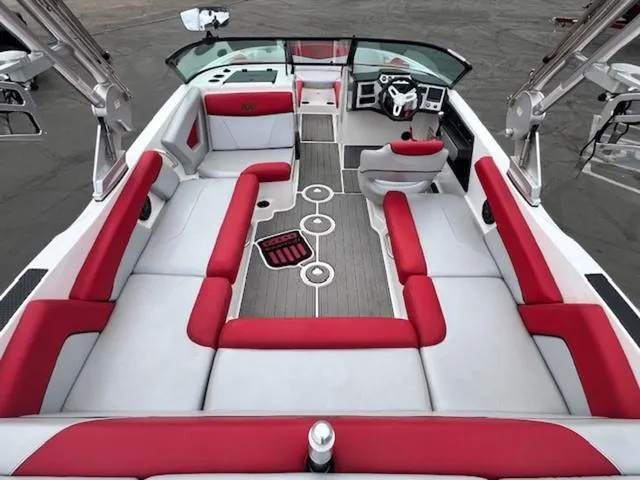 Slide: The Image of 2018 MasterCraft NXT22 boat interior with red and gray seating, modern dashboard, and spacious layout. - 10