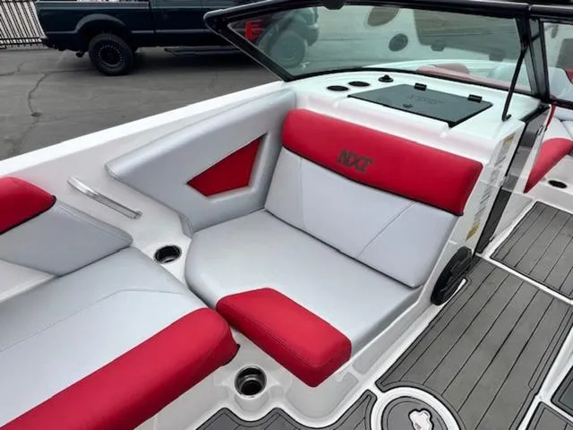 Slide: The Image of 2018 MasterCraft NXT22 boat interior with red and white seating, modern design. - 12
