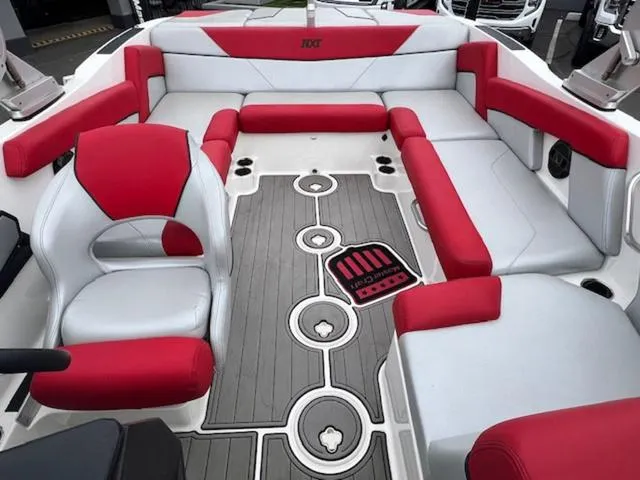 Slide: The Image of 2018 MasterCraft NXT22 boat interior with red and gray seating and stylish flooring. - 17
