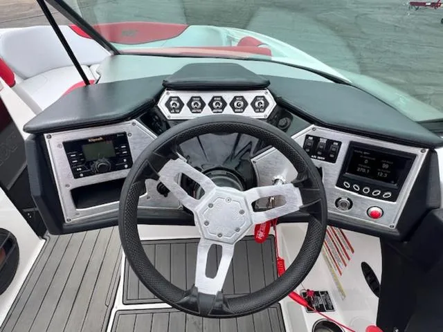 Slide: The Image of 2018 MasterCraft NXT22 boat dashboard with steering wheel and control panels. - 18