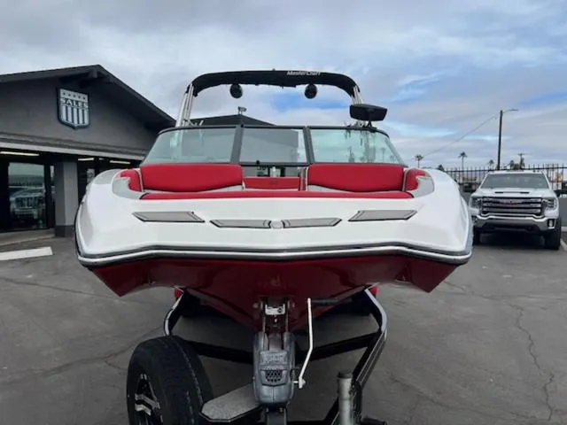 Slide: The Image of 2018 MasterCraft NXT22 boat with red and white design on a trailer. - 3