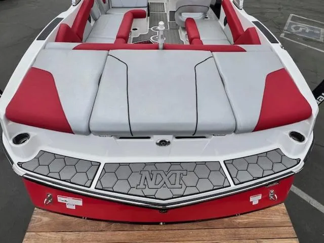 Slide: The Image of 2018 MasterCraft NXT22 boat with red and gray seating, viewed from the rear. - 9