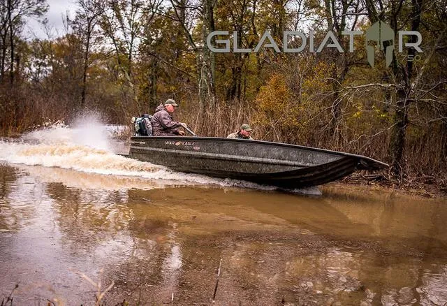 Slide: The Image of War Eagle MODEL 750 - GLADIATOR 2025 navigating through a forested waterway. - 1