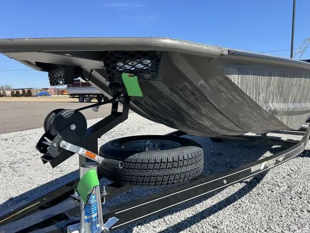 Slide: The Image of 2025 War Eagle MODEL 750 - GLADIATOR boat on trailer, gravel lot background. - 5