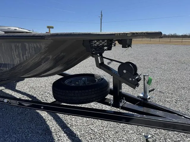 Slide: The Image of War Eagle MODEL 750 - GLADIATOR boat trailer with spare tire on gravel lot, 2025 model. - 6