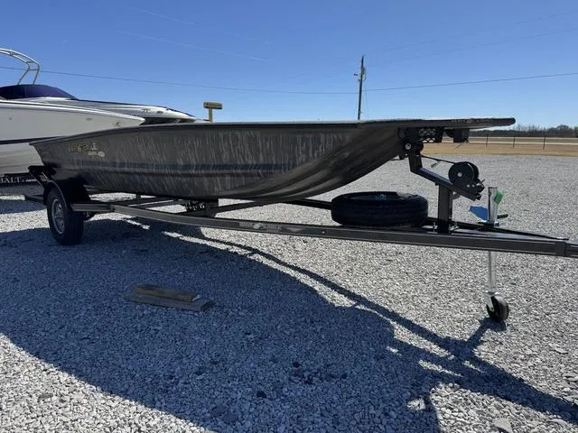 Slide: The Image of 2025 War Eagle MODEL 750 - GLADIATOR boat on trailer in gravel lot. - 7