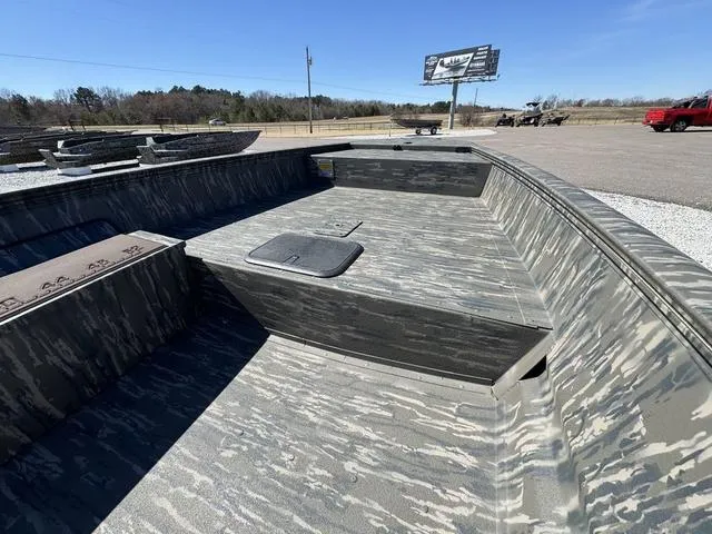 Slide: The Image of 2025 War Eagle MODEL 750 - GLADIATOR boat with camouflage design in outdoor setting. - 9